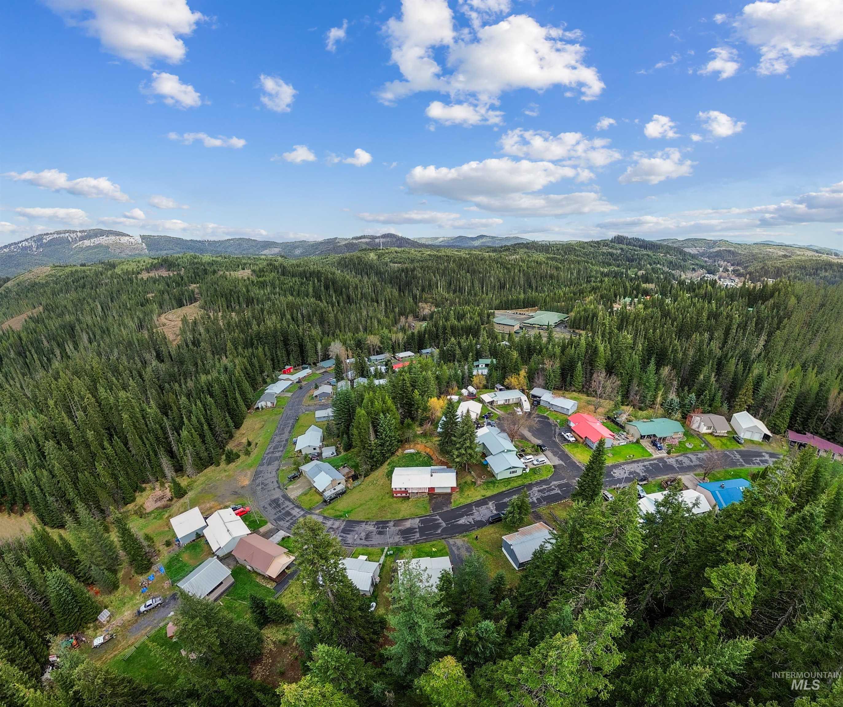 145 Timberline Drive Pierce, ID 83546 - Photo 38 of 39 Aerial perspective showcasing a residential community nestled within a vast evergreen forest