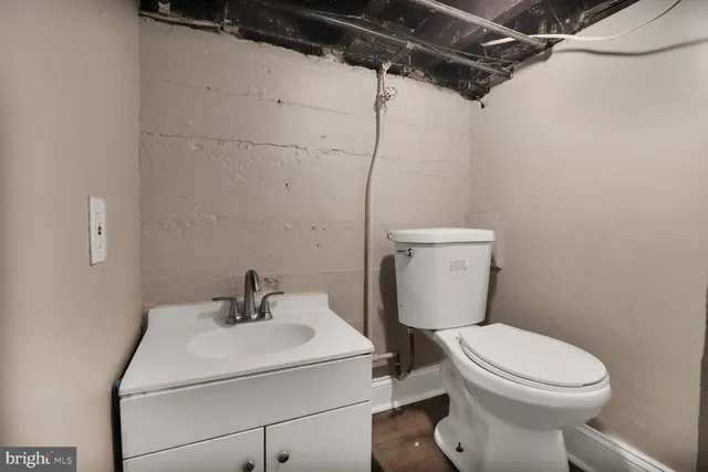 a white toilet sitting next to a bathroom sink
