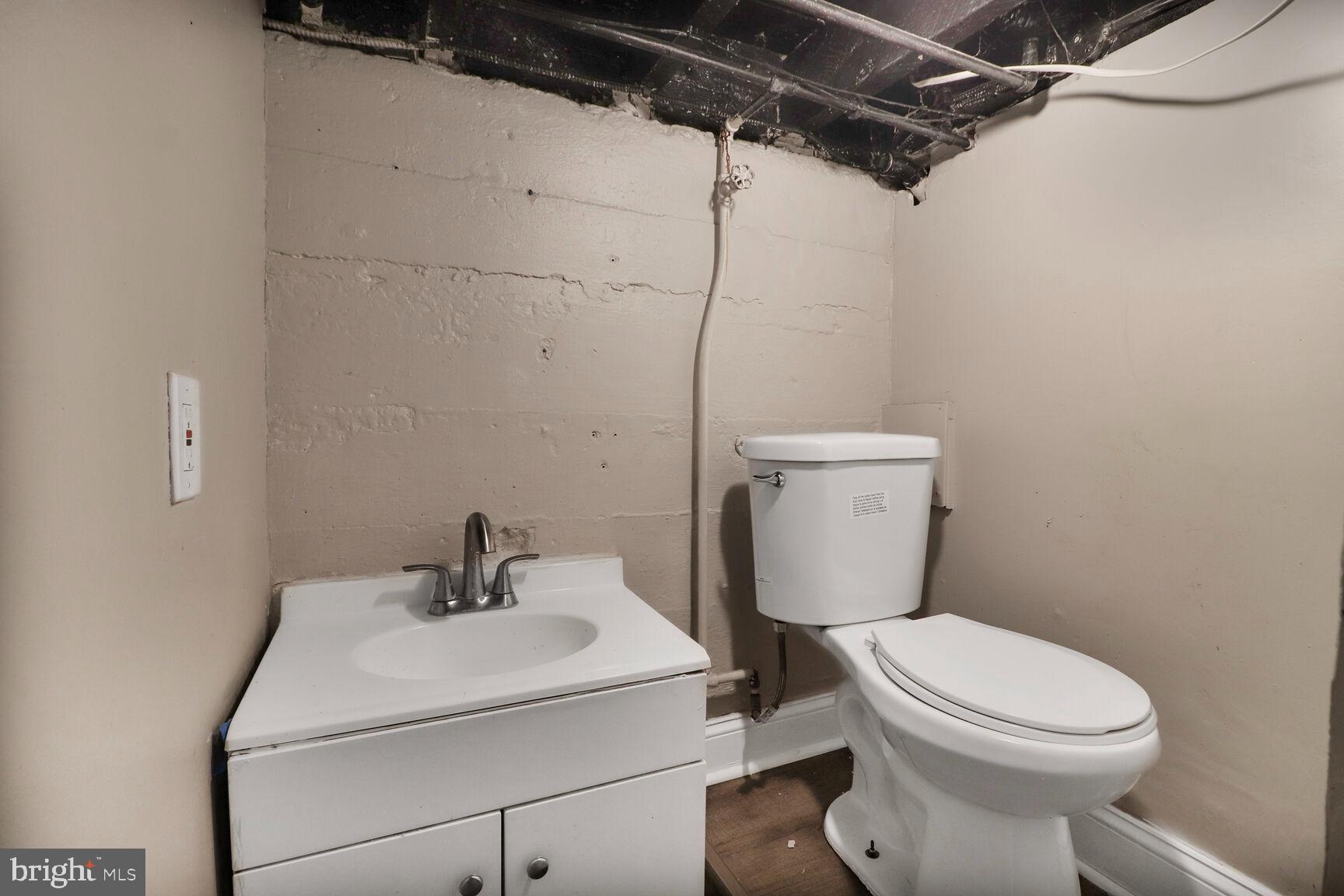 4122 Eierman Avenue Baltimore, MD 21206 - Photo 9 of 13 a white toilet sitting next to a bathroom sink
