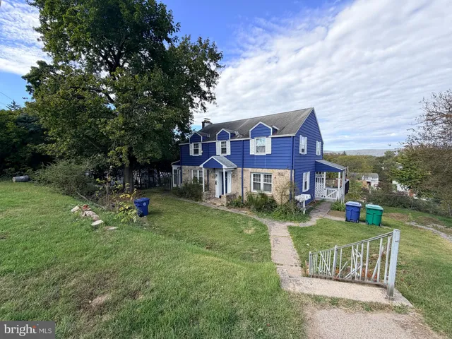a view of a house with a yard and deck