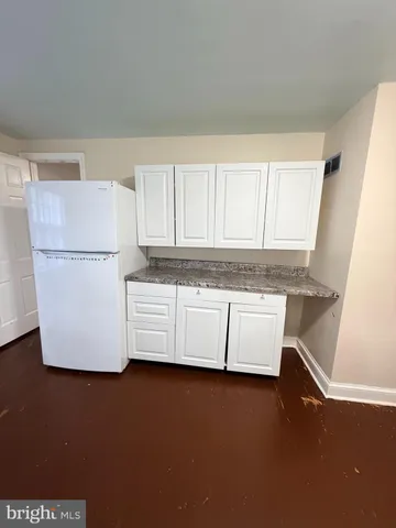 a white refrigerator freezer sitting in a kitchen