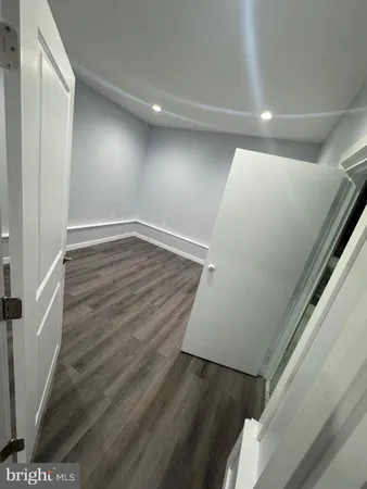 a view of hallway with wooden floor