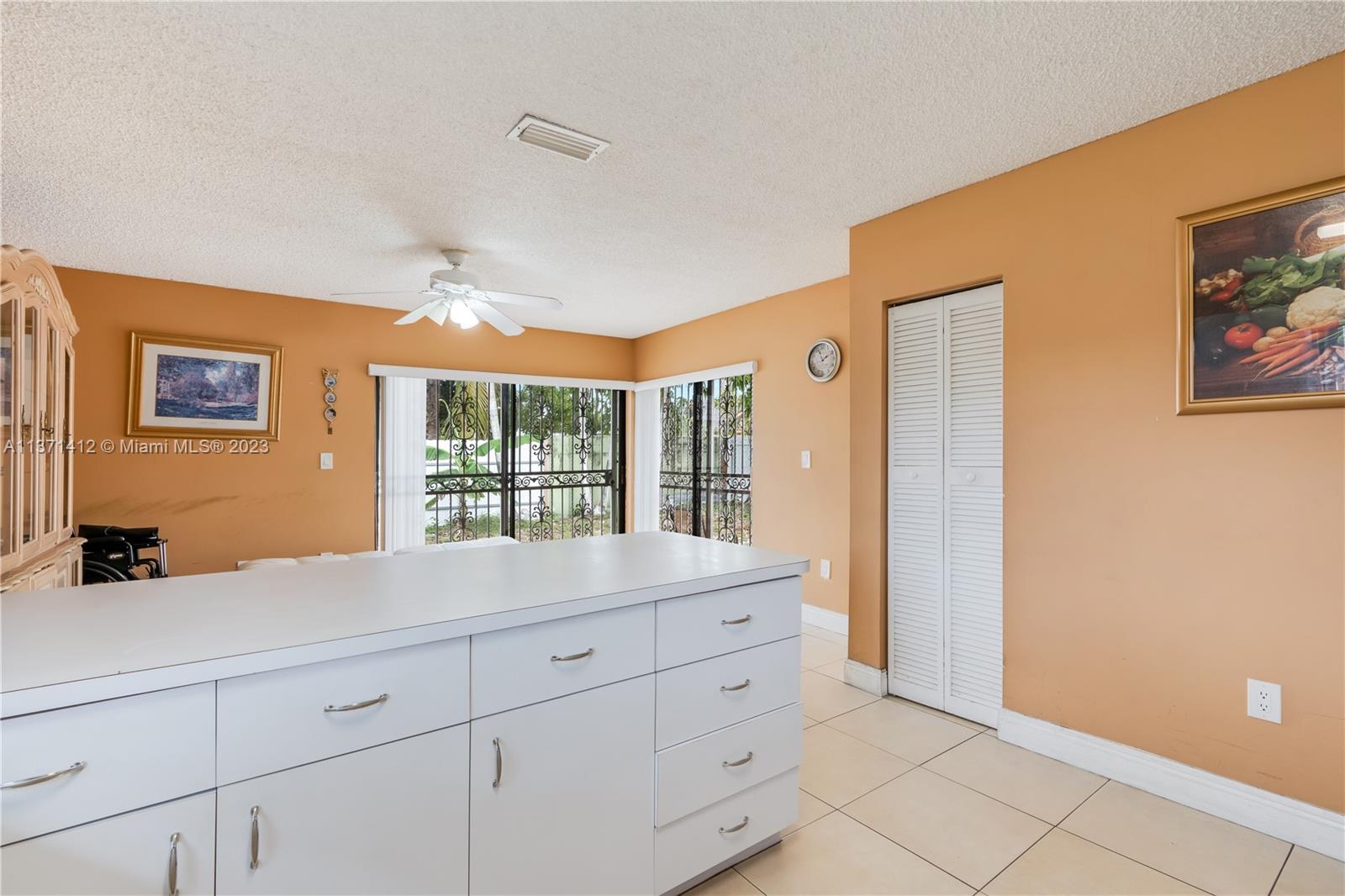 13817 Southwest 21st Terrace Miami, FL 33175 - Photo 13 of 37 a room with a large bed and a window