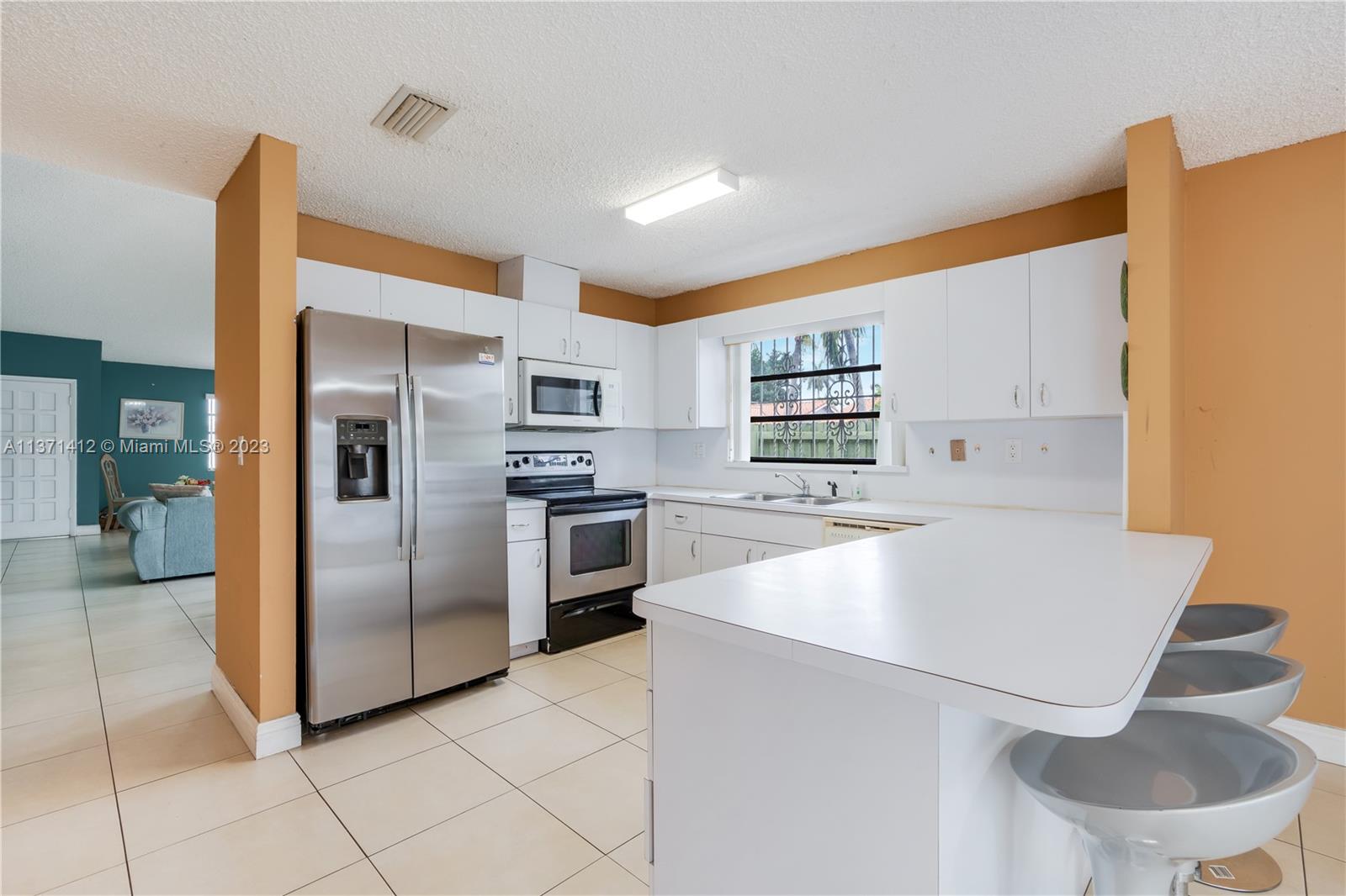 13817 Southwest 21st Terrace Miami, FL 33175 - Photo 14 of 37 a kitchen with stainless steel appliances a refrigerator and a stove