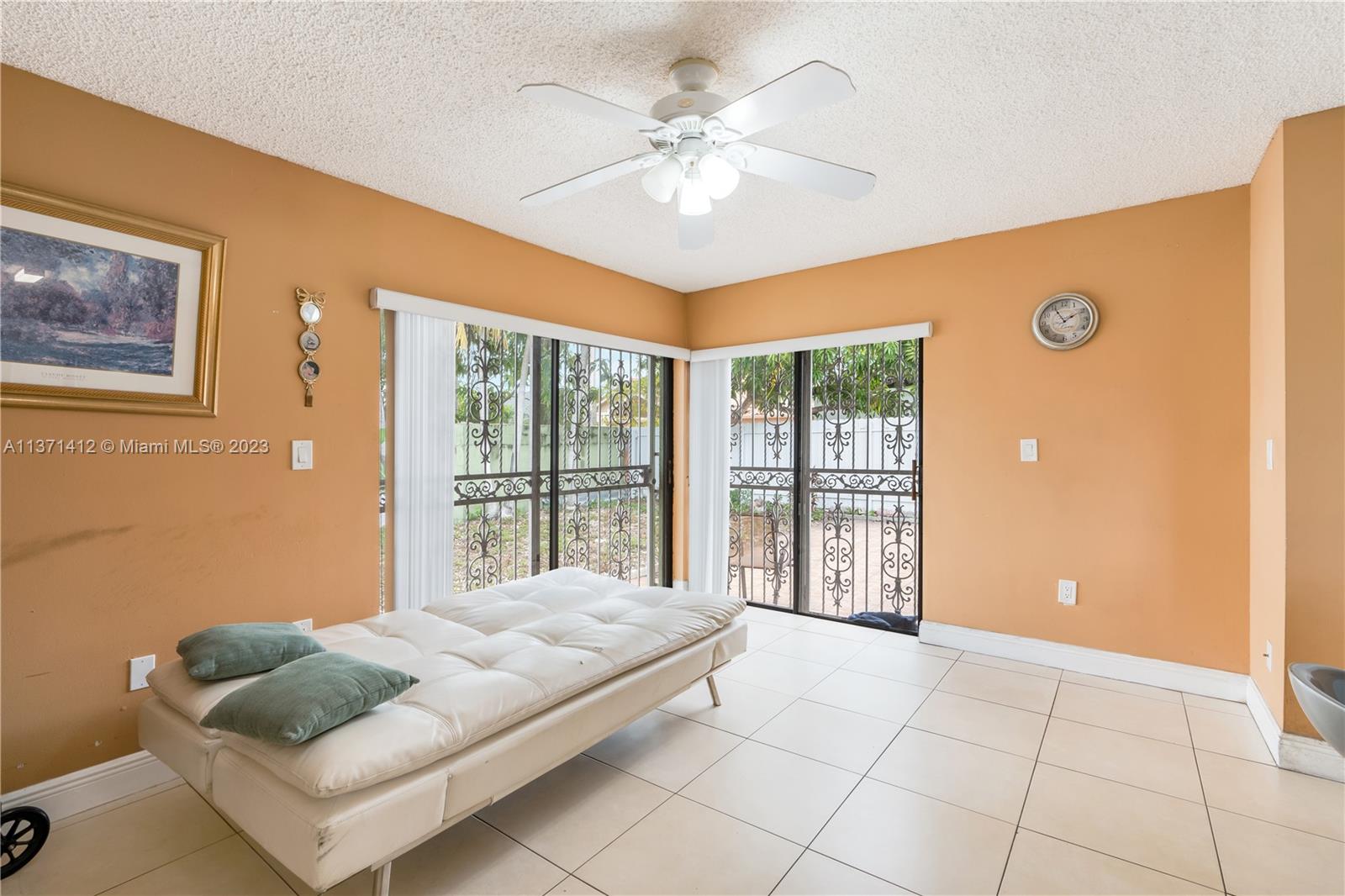 13817 Southwest 21st Terrace Miami, FL 33175 - Photo 17 of 37 a living room with furniture and a large window