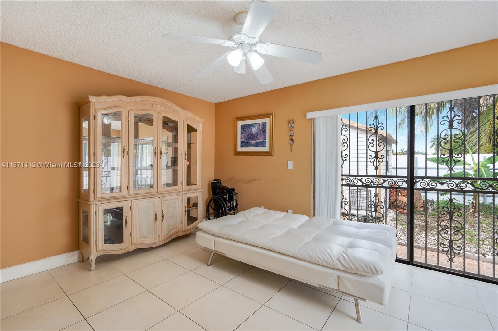 13817 Southwest 21st Terrace Miami, FL 33175 - Photo 19 of 37 a spacious bedroom with a large bed and a chandelier