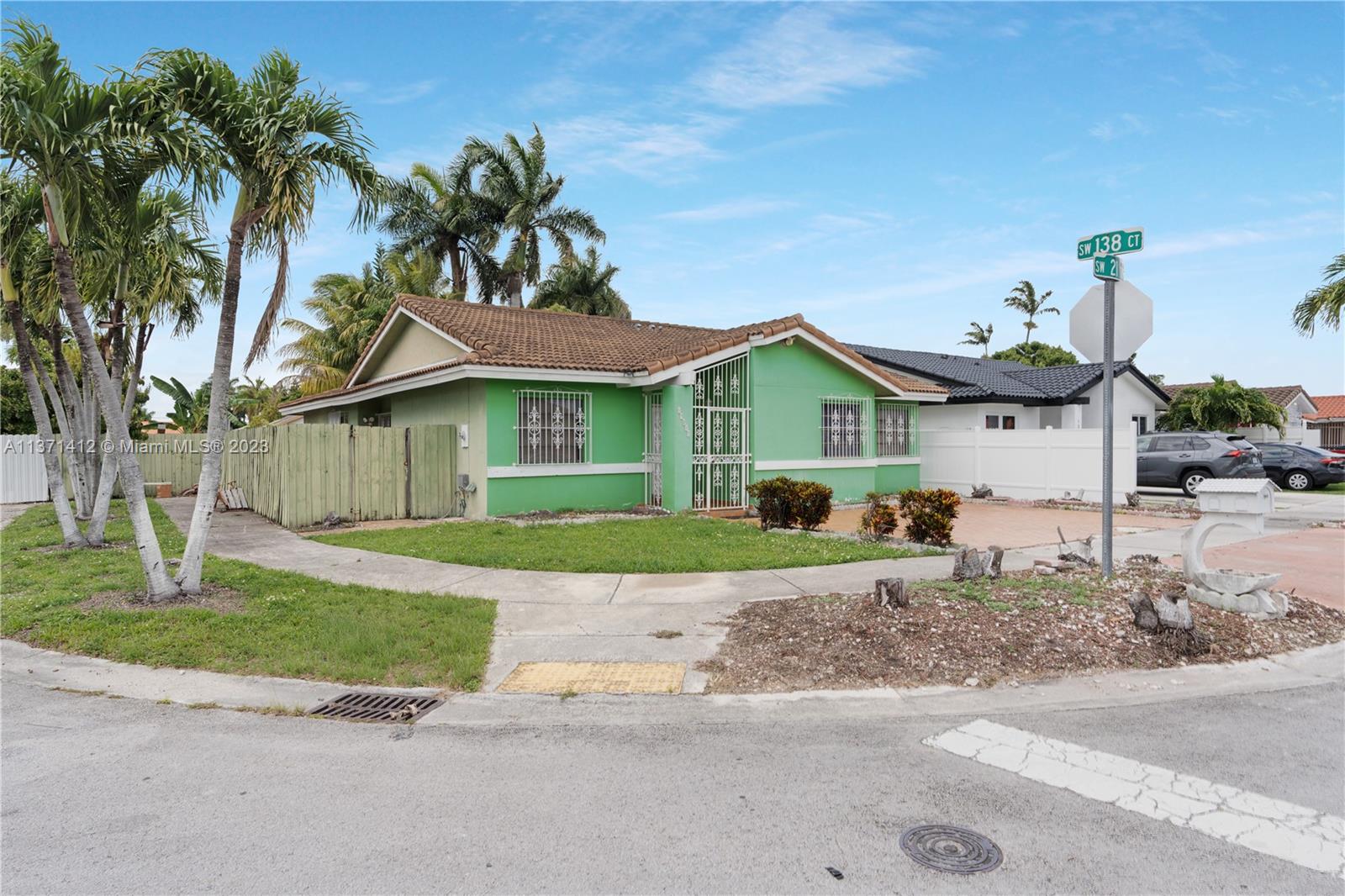 13817 Southwest 21st Terrace Miami, FL 33175 - Photo 2 of 37 a front view of a house with garden