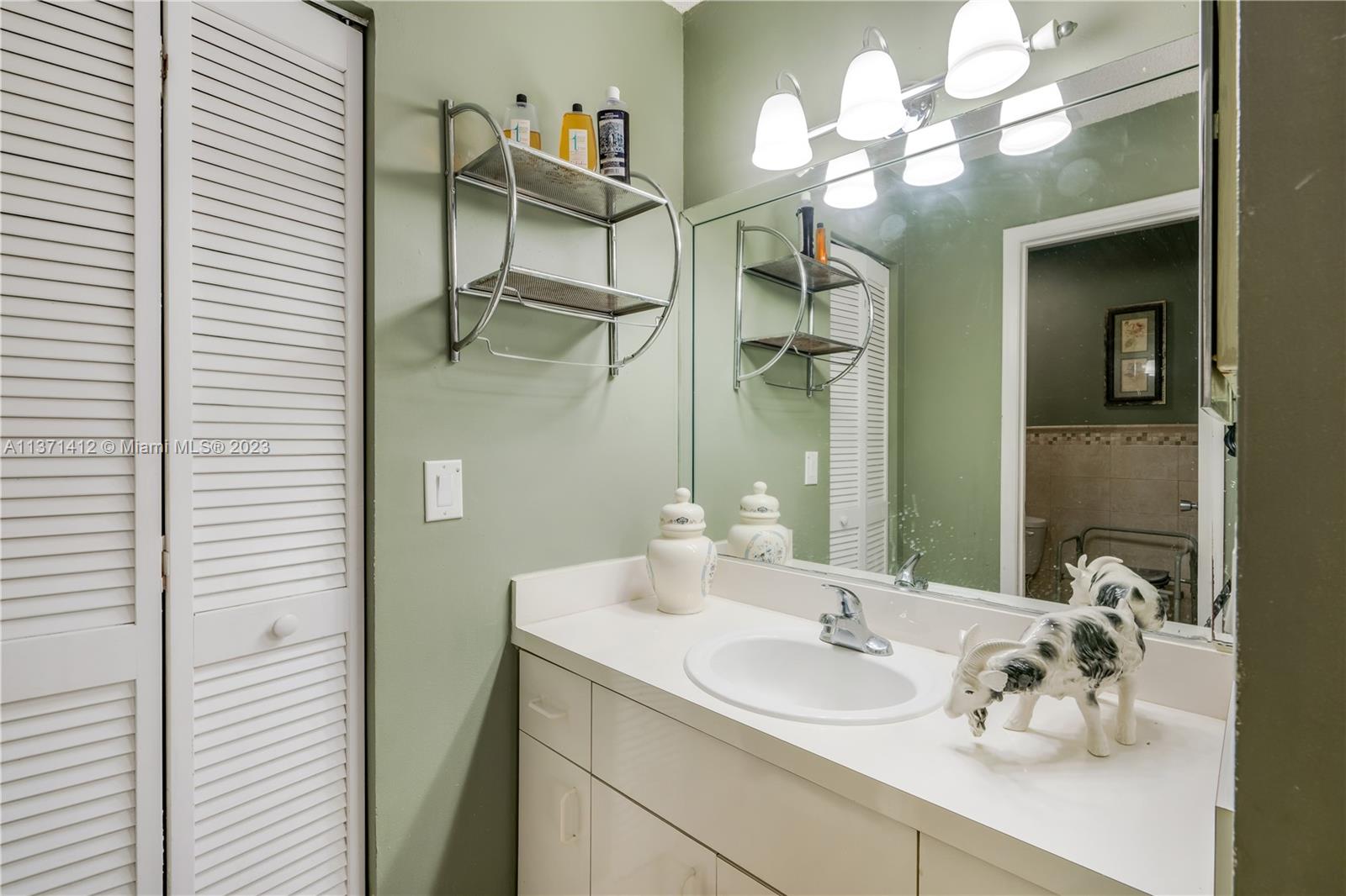 13817 Southwest 21st Terrace Miami, FL 33175 - Photo 24 of 37 a bathroom with a sink vanity and a mirror