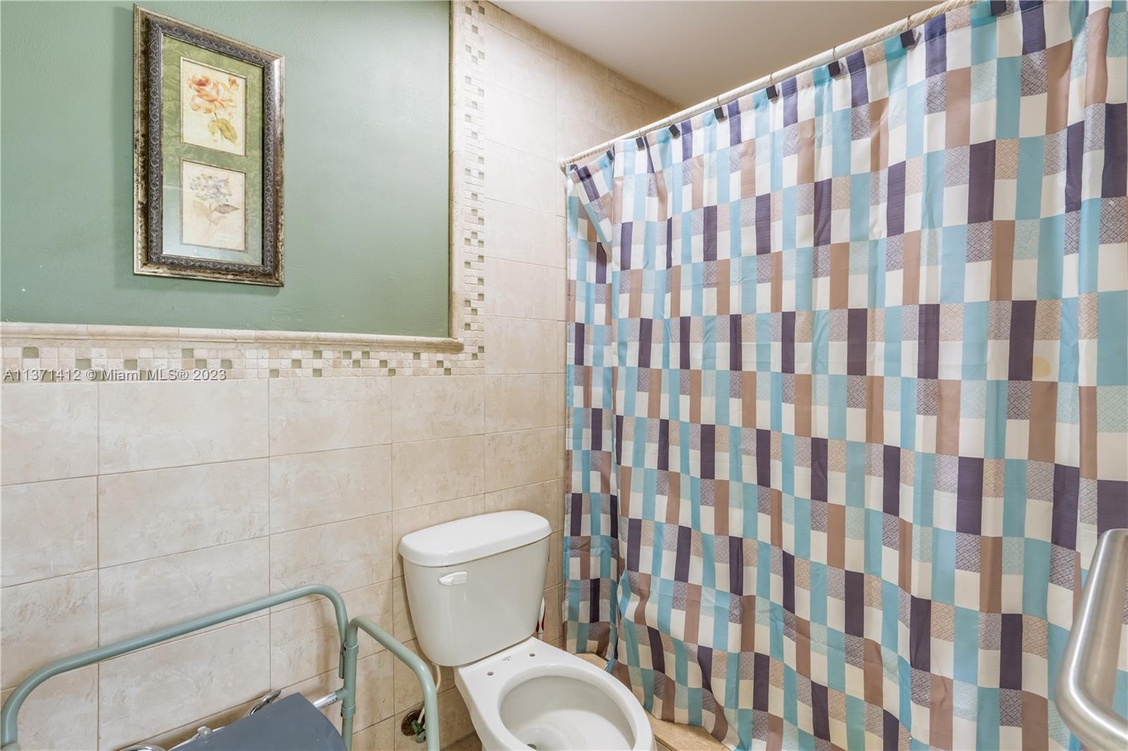 13817 Southwest 21st Terrace Miami, FL 33175 - Photo 25 of 37 a white toilet sitting next to a shower curtain