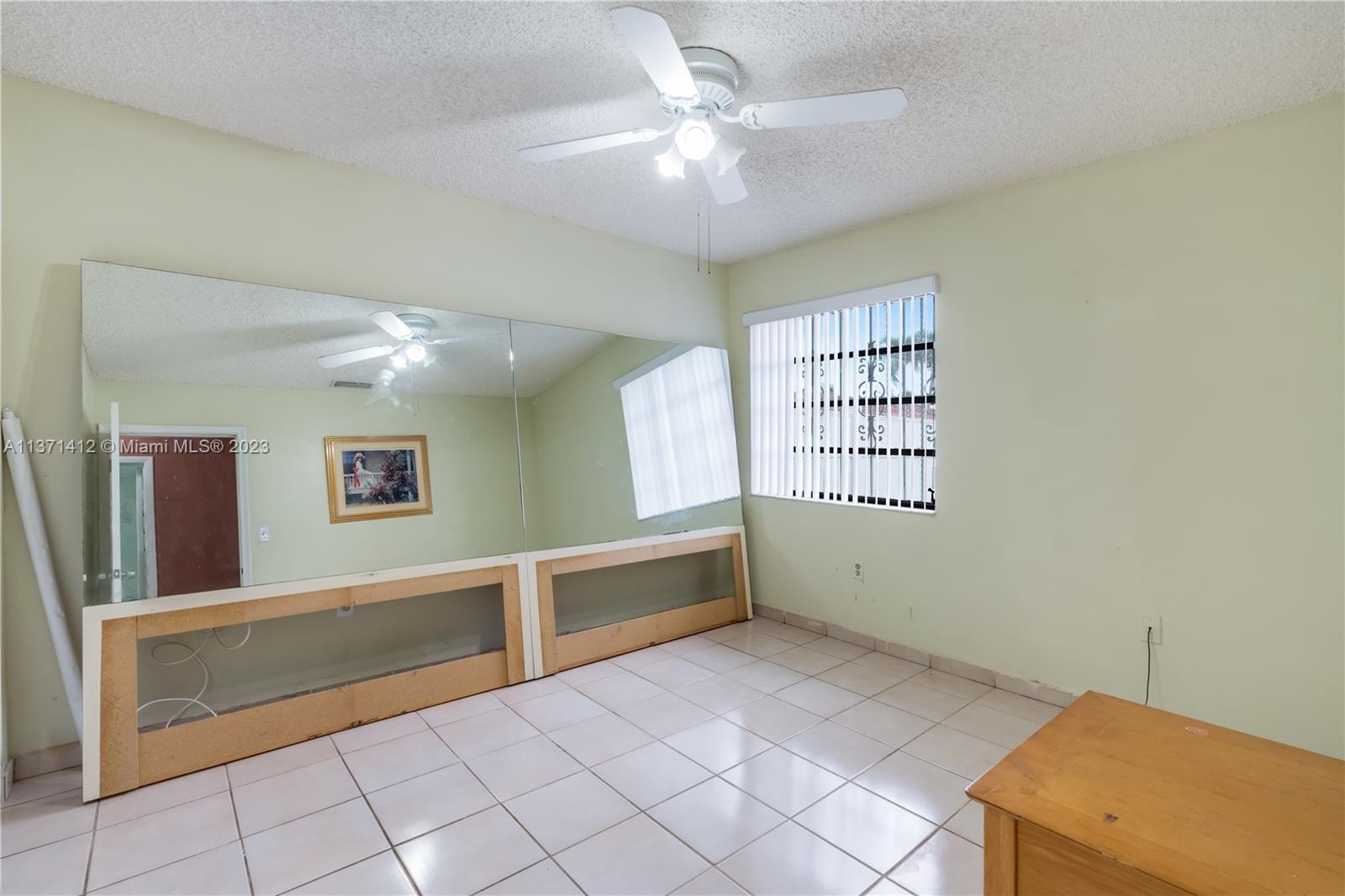 13817 Southwest 21st Terrace Miami, FL 33175 - Photo 28 of 37 a view of workspace with window and a ceiling fan