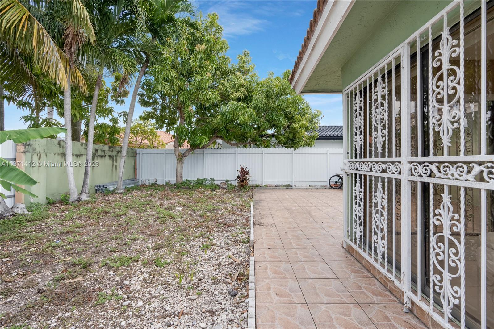 13817 Southwest 21st Terrace Miami, FL 33175 - Photo 35 of 37 a view of a house with a small yard and wooden fence