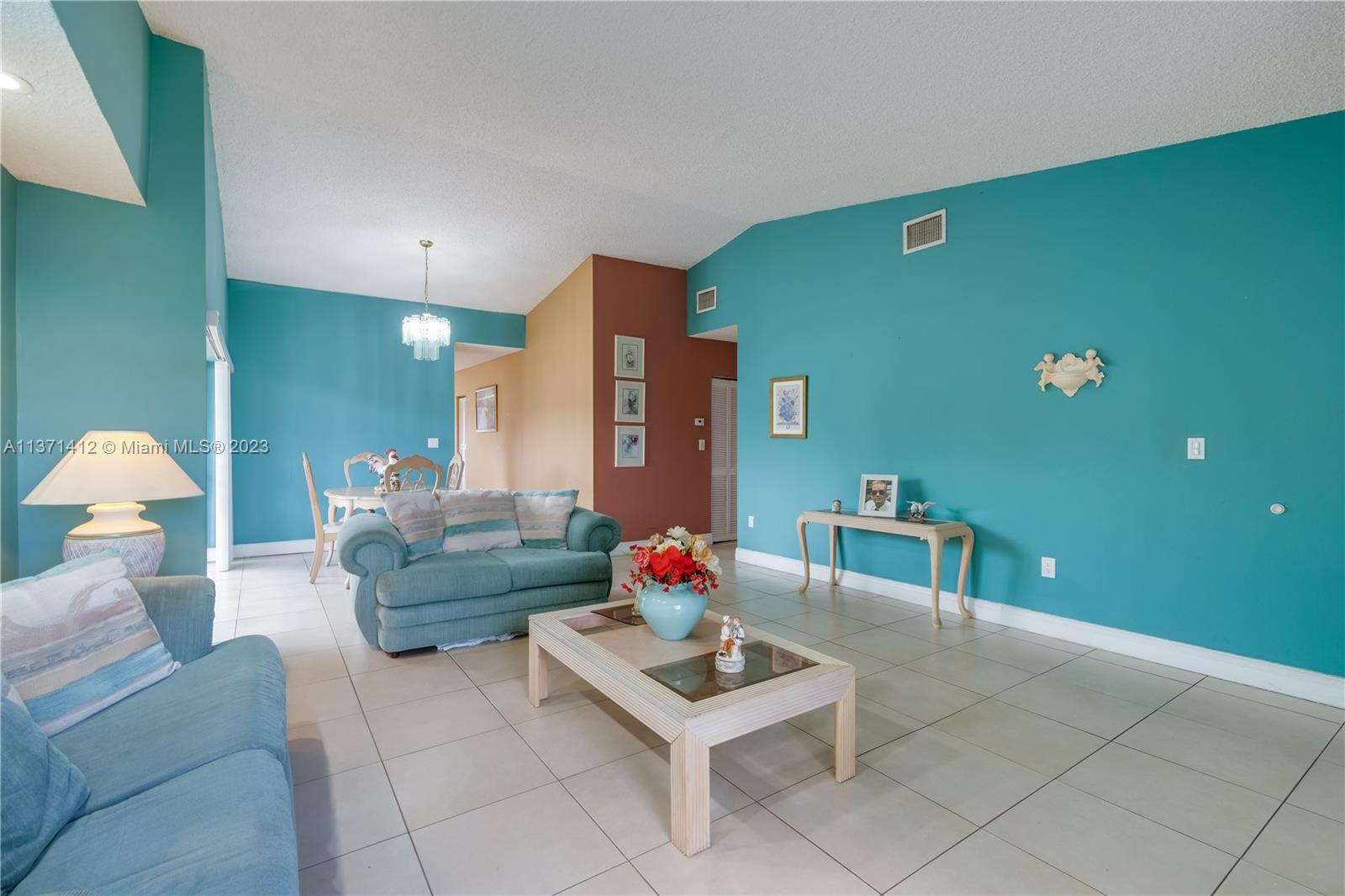 13817 Southwest 21st Terrace Miami, FL 33175 - Photo 6 of 37 a living room with furniture and a wall painting