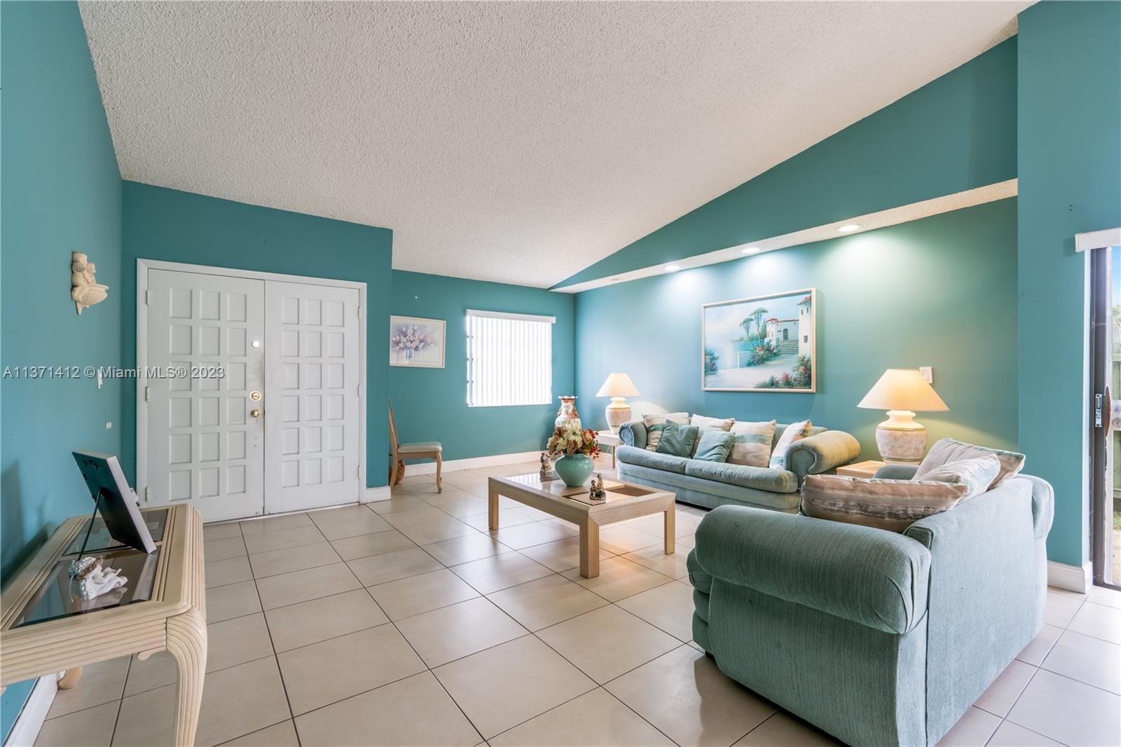 13817 Southwest 21st Terrace Miami, FL 33175 - Photo 7 of 37 a living room with furniture and a flat screen tv
