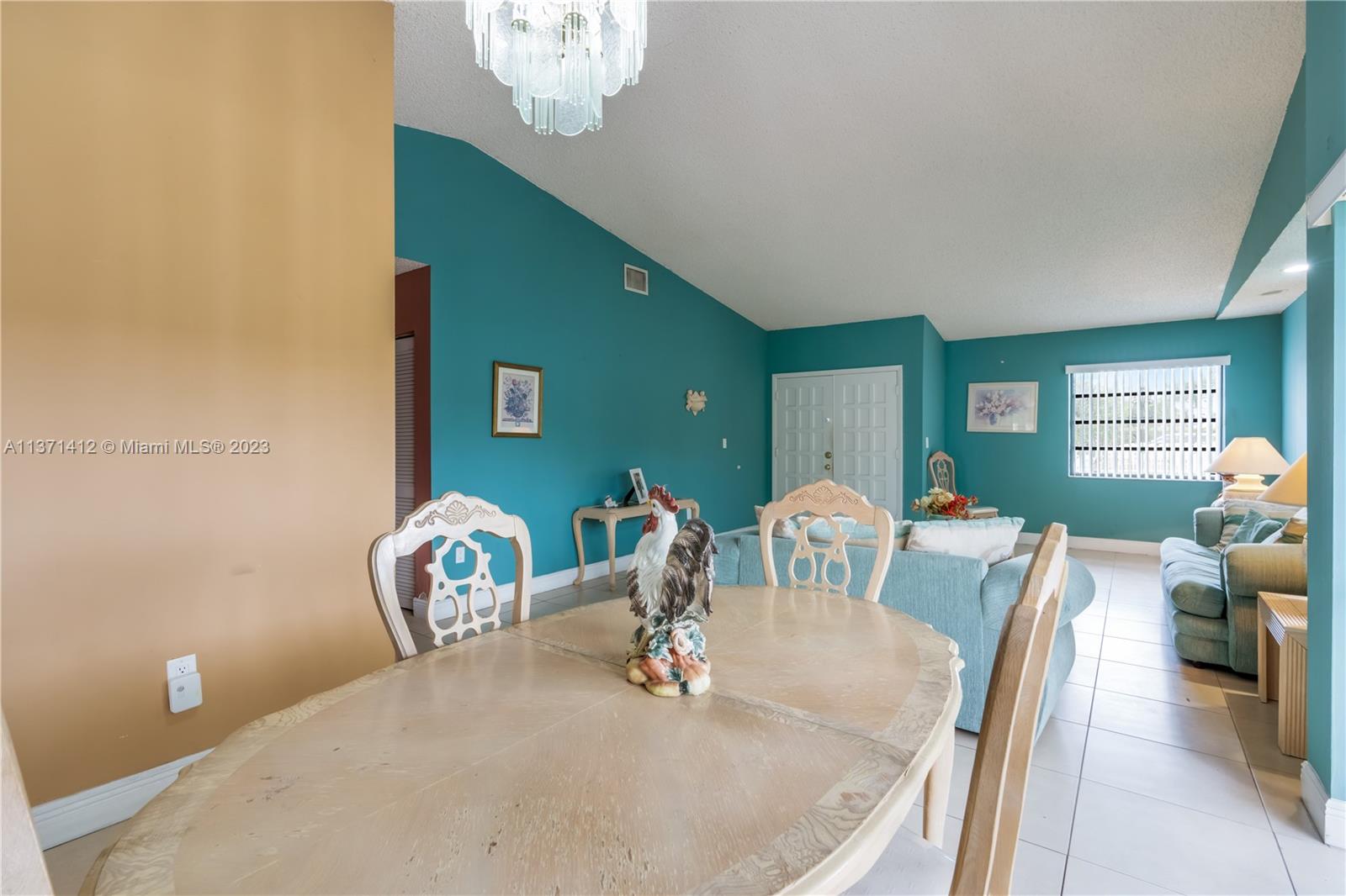 13817 Southwest 21st Terrace Miami, FL 33175 - Photo 10 of 37 a dining room with furniture a chandelier and wooden floor
