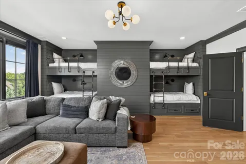 a bed room with a bed and a chandelier