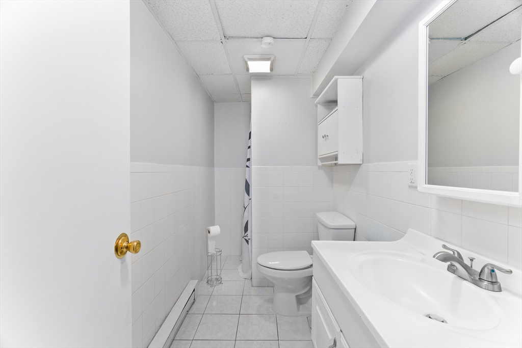 1039 South Main Street Fall River, MA 02724 - Photo 12 of 39 a bathroom with a sink a toilet and shower