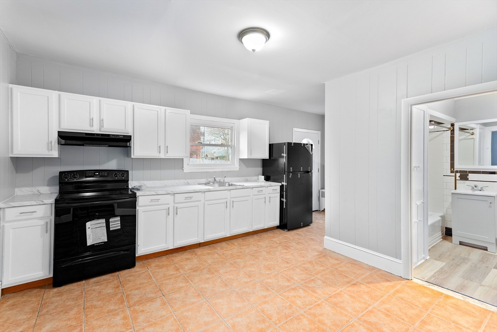 1039 South Main Street Fall River, MA 02724 - Photo 15 of 39 a kitchen with stainless steel appliances a refrigerator stove and sink