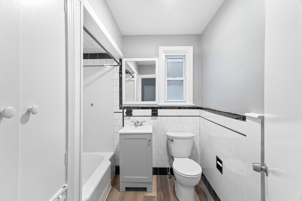 1039 South Main Street Fall River, MA 02724 - Photo 18 of 39 a bathroom with a sink a toilet a mirror and shower