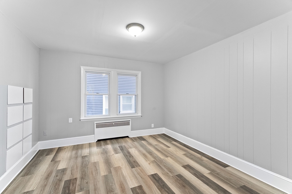 1039 South Main Street Fall River, MA 02724 - Photo 19 of 39 wooden floor in an empty room with a window