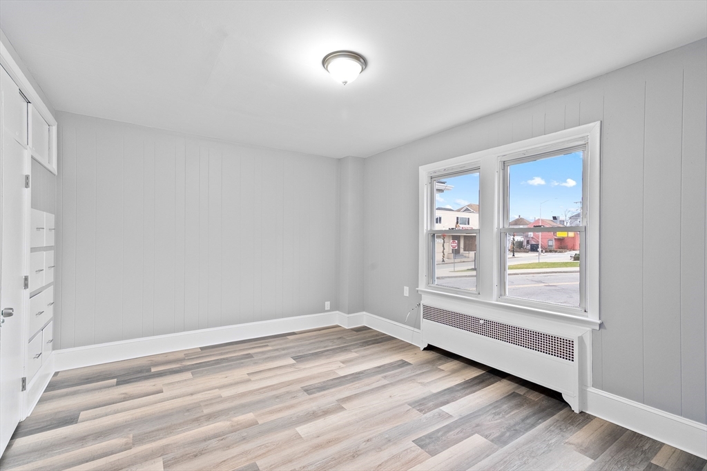 1039 South Main Street Fall River, MA 02724 - Photo 20 of 39 a view of an empty room with wooden floor and a window