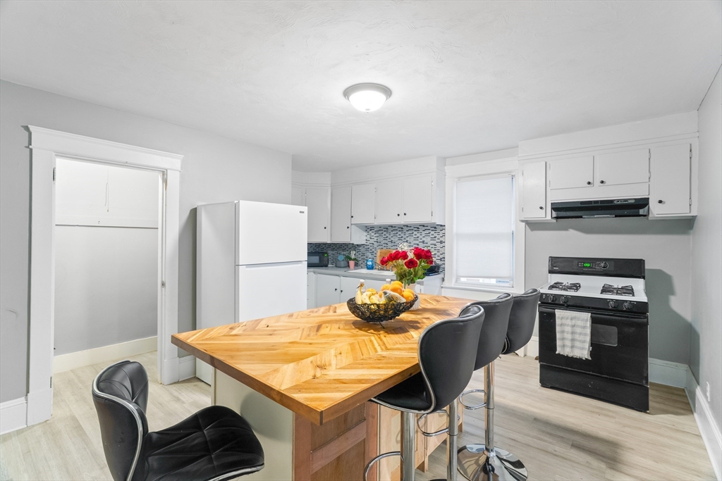 1039 South Main Street Fall River, MA 02724 - Photo 23 of 39 a view of a dining room with furniture and a kitchen