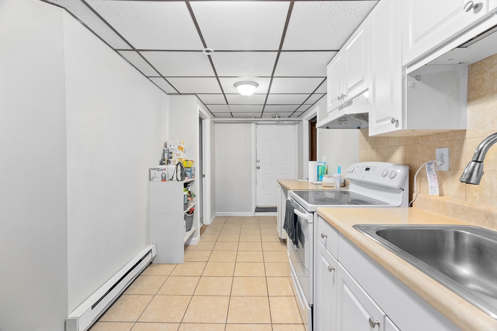 1039 South Main Street Fall River, MA 02724 - Photo 26 of 39 a kitchen with a sink a refrigerator and washer