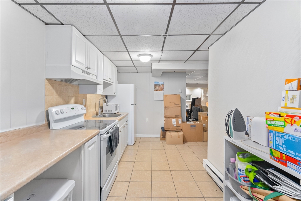 1039 South Main Street Fall River, MA 02724 - Photo 27 of 39 a kitchen with stainless steel appliances granite countertop lots of clutter and stainless steel appliances