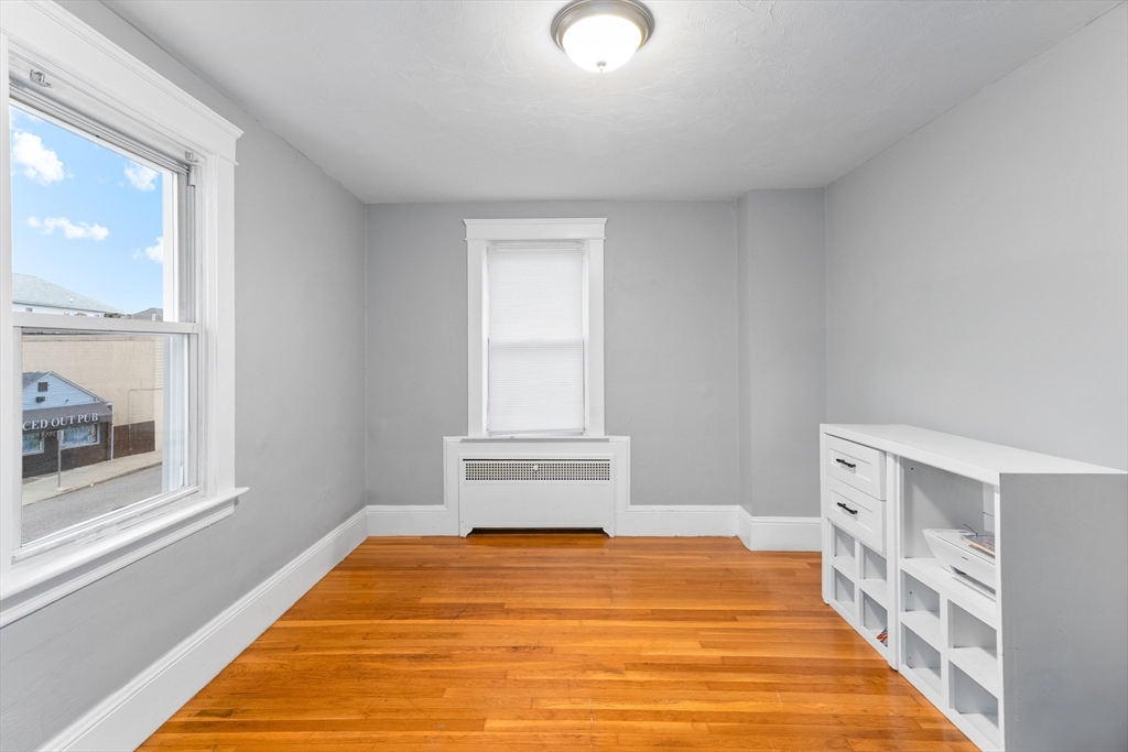 1039 South Main Street Fall River, MA 02724 - Photo 8 of 39 a bedroom with a bed and window