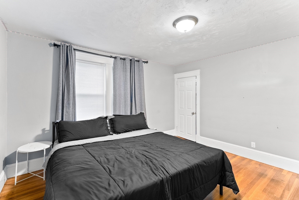 1039 South Main Street Fall River, MA 02724 - Photo 10 of 39 a bedroom with a bed and a window