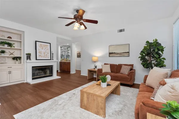 a living room with furniture a window and a fireplace