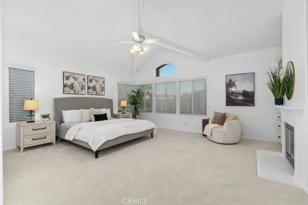 a spacious bedroom with a bed and large window
