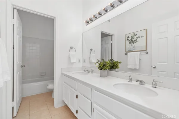 a bathroom with a bathtub shower sink and mirror