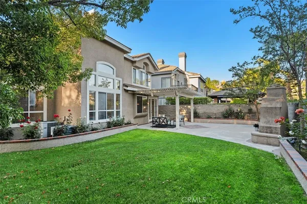 a front view of a house with a yard and sitting area