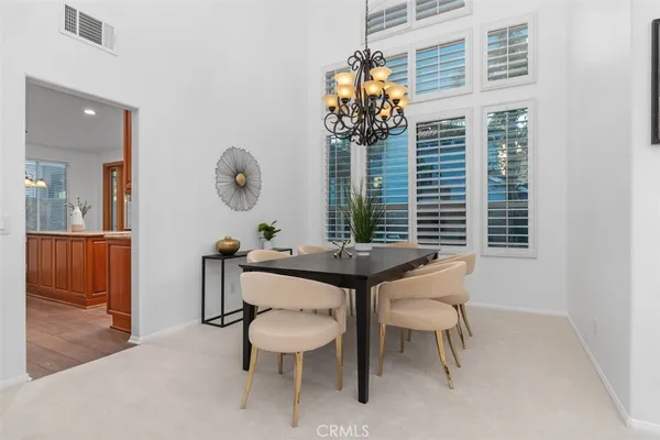 a view of a room with a table and chairs