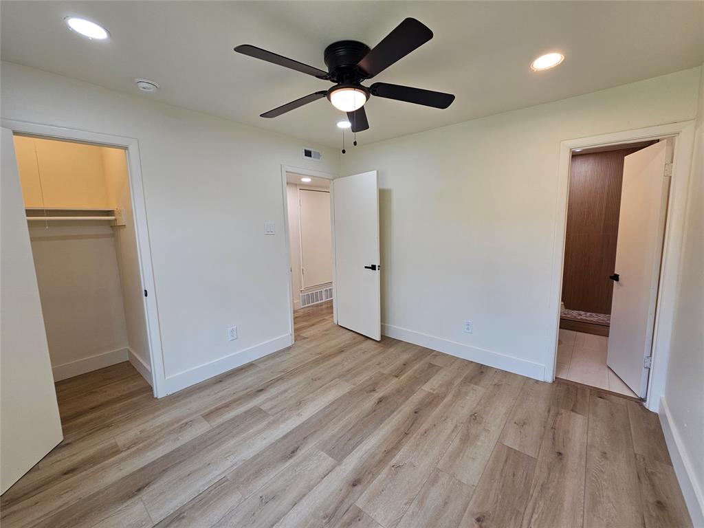1725 R Avenue, Unit 1727 Plano, TX 75074 - Photo 13 of 20 Room featuring wood-finish flooring, recessed lighting, and a black ceiling fan with integrated lighting