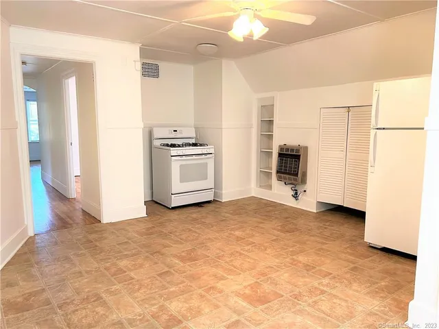 a view of a kitchen with a stove cabinets and a refrigerator