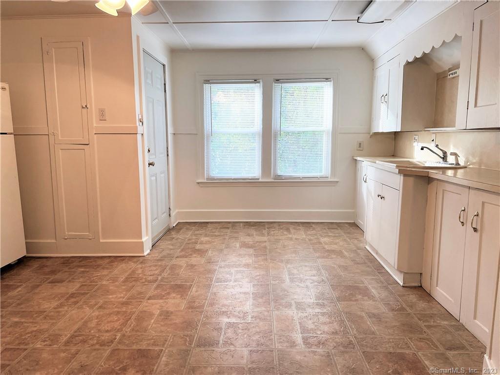 122 Derby Avenue, Unit 3 Seymour, CT 06483 - Photo 3 of 8 a view of a kitchen with a sink and dishwasher with wooden floor