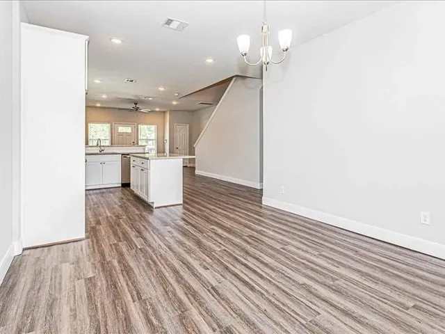 a view of a room with wooden floor and staircase