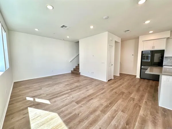 a view of a livingroom with kitchen and the view of the window