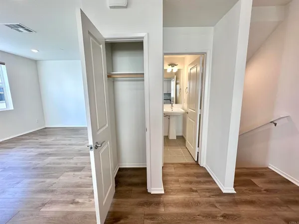 a view of a hallway with wooden floor and entryway