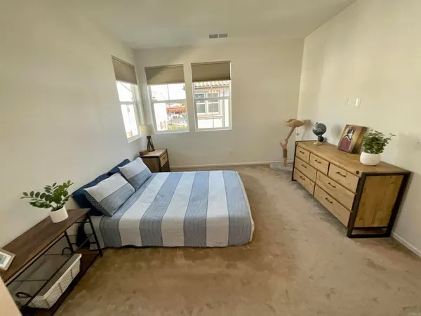 a bed sitting in a bedroom next to a window