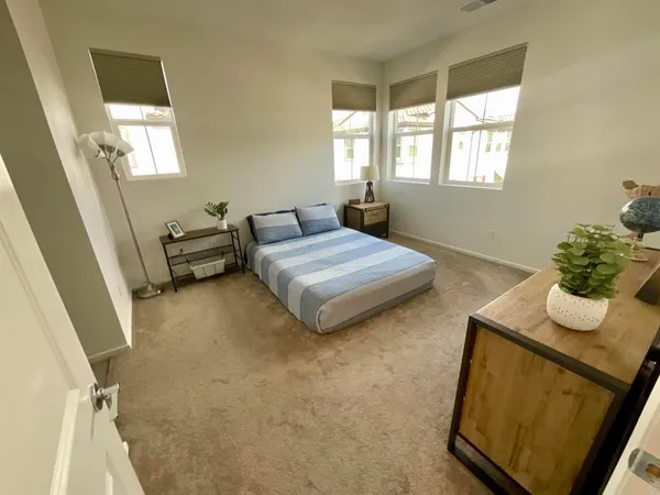 a bedroom with a bed and a window