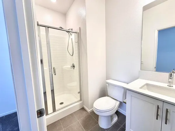 a bathroom with a toilet sink and shower