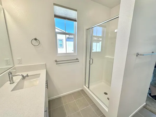 a bathroom with a tub sink and shower