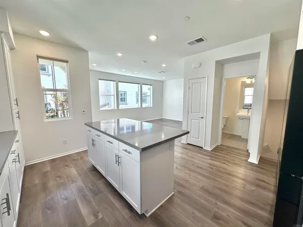 a kitchen with granite countertop a sink and wooden floor