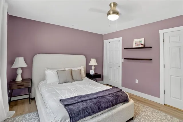 a bedroom with a bed and a lamp