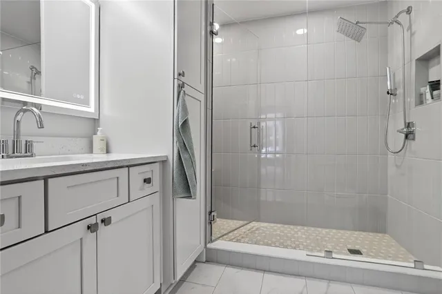 a bathroom with a shower sink and mirror