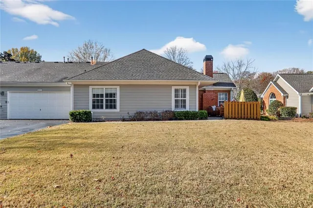 a view of a house with a yard and garage