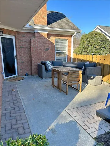 a view of a patio with a table and chairs