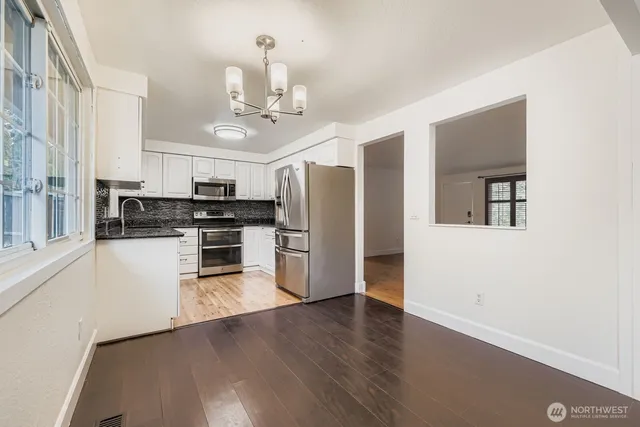 a kitchen with stainless steel appliances a refrigerator and a stove top oven
